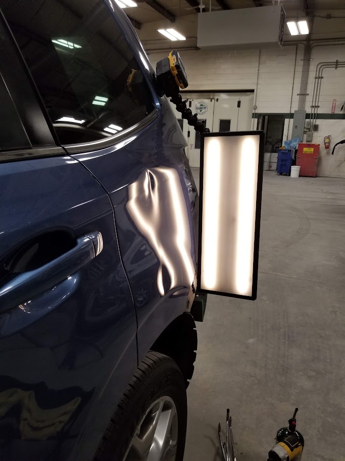 Blue SUV rear quarter panel after paintless dent repair